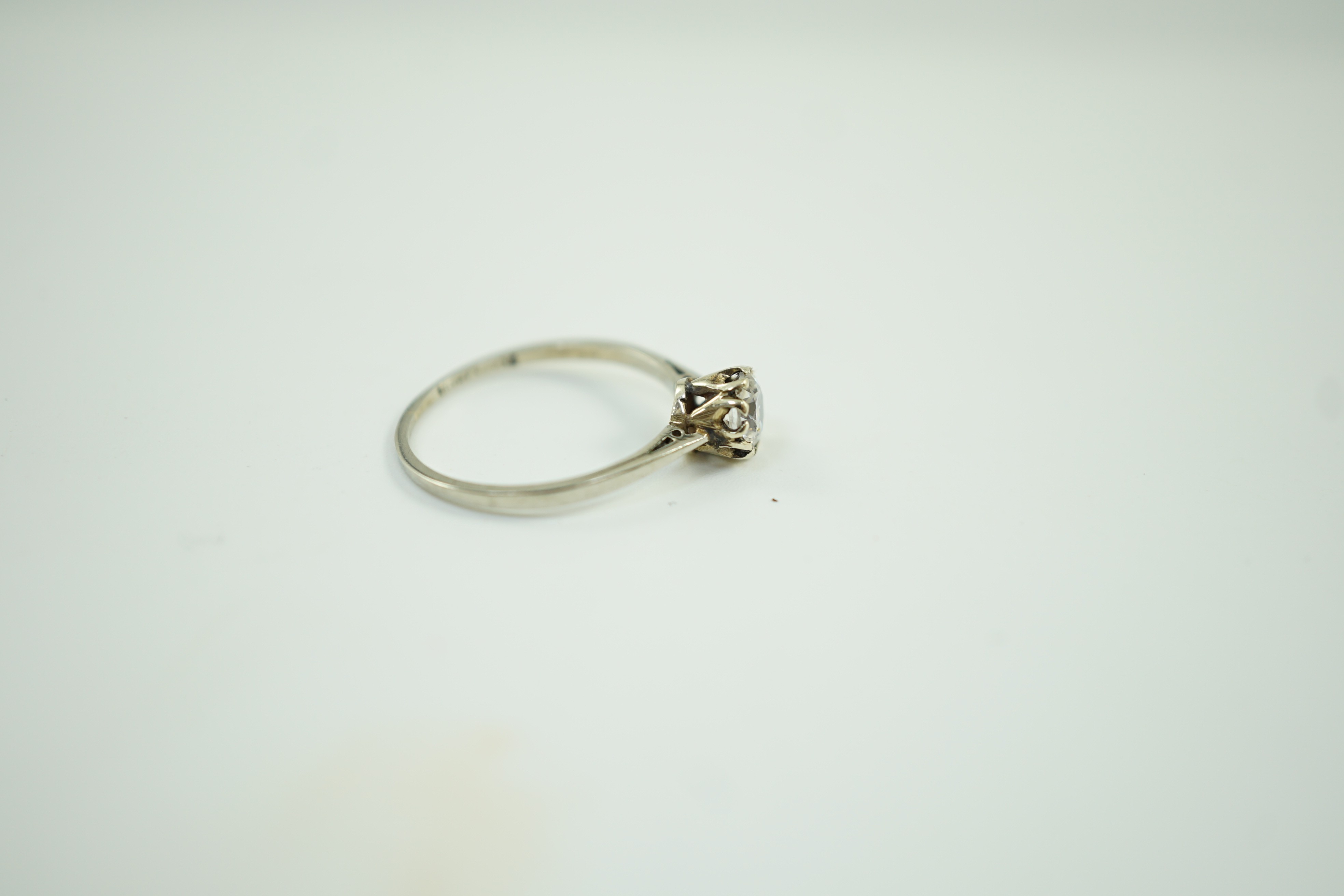 An 18ct and plat set and simulated diamond ring, the stone diameter approx. 4.5mm, size J, gross weight 1.1 grams.